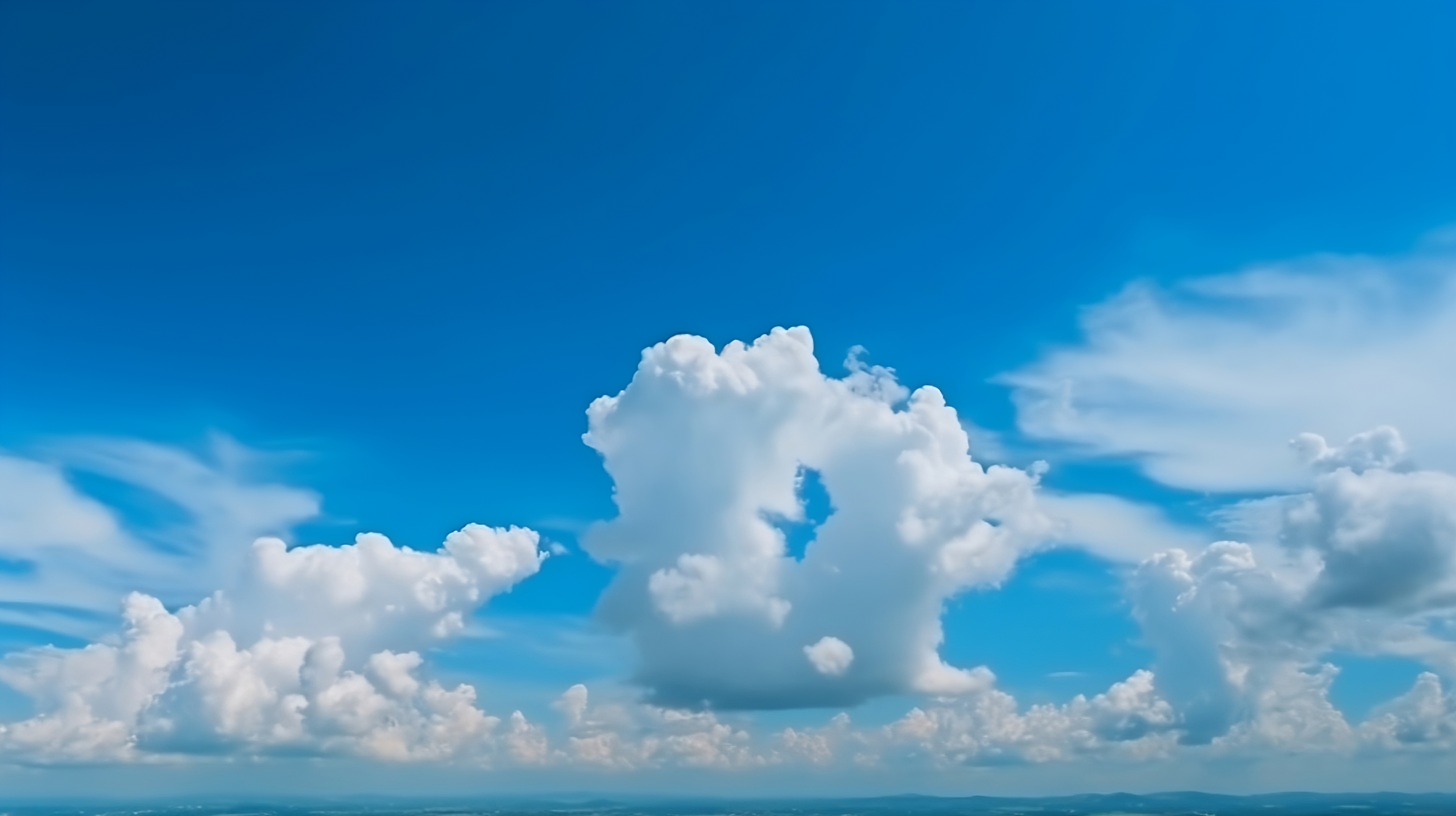 A beautiful blue sky with fluffy white clouds floating in the background