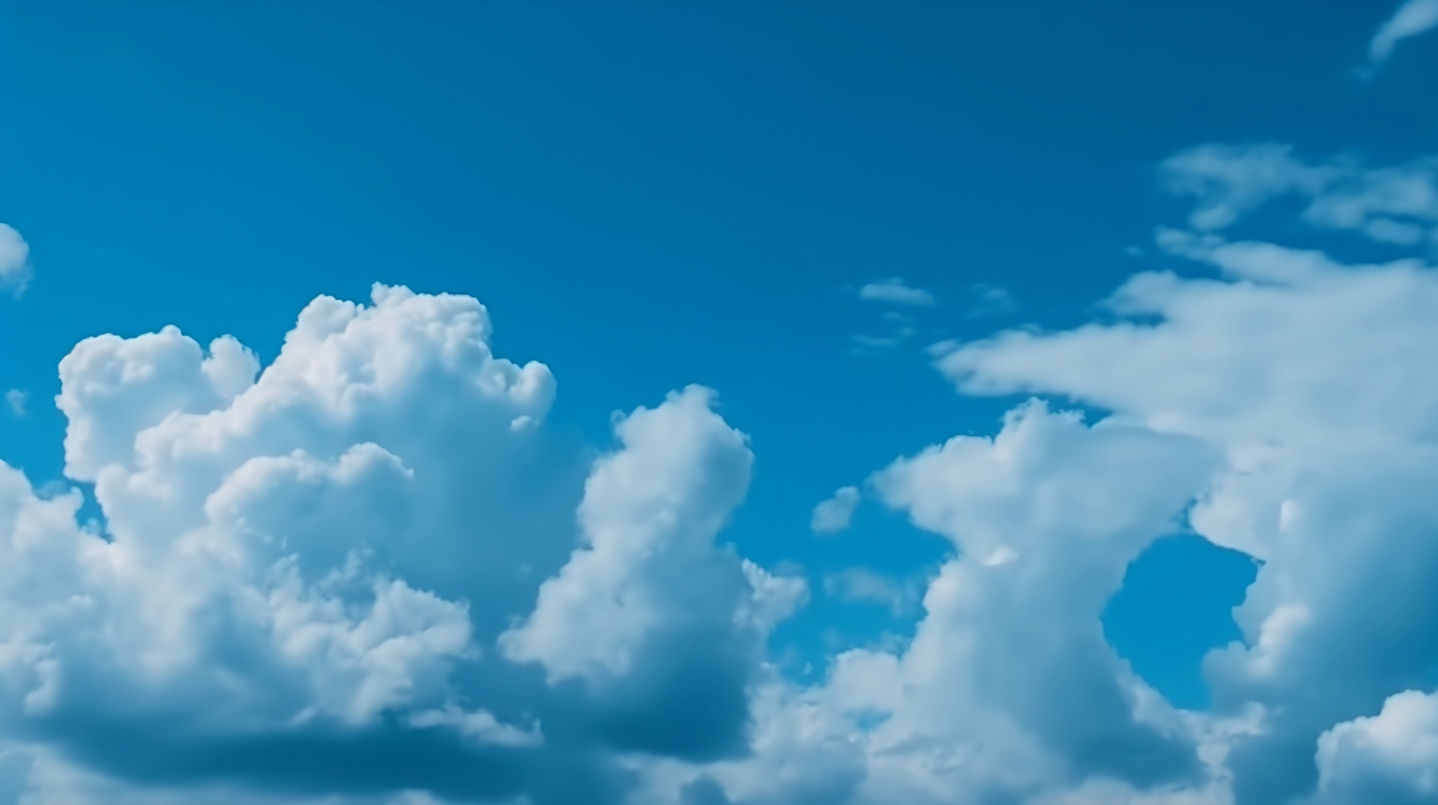 A beautiful blue sky with fluffy white clouds floating in the background