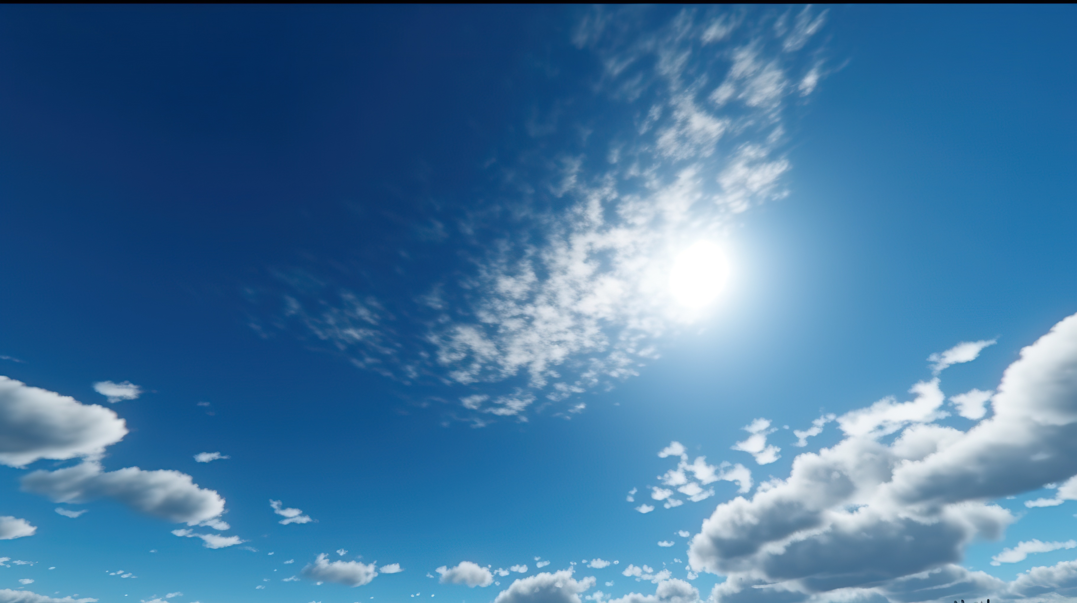 A clear blue sky with fluffy white clouds scattered throughout