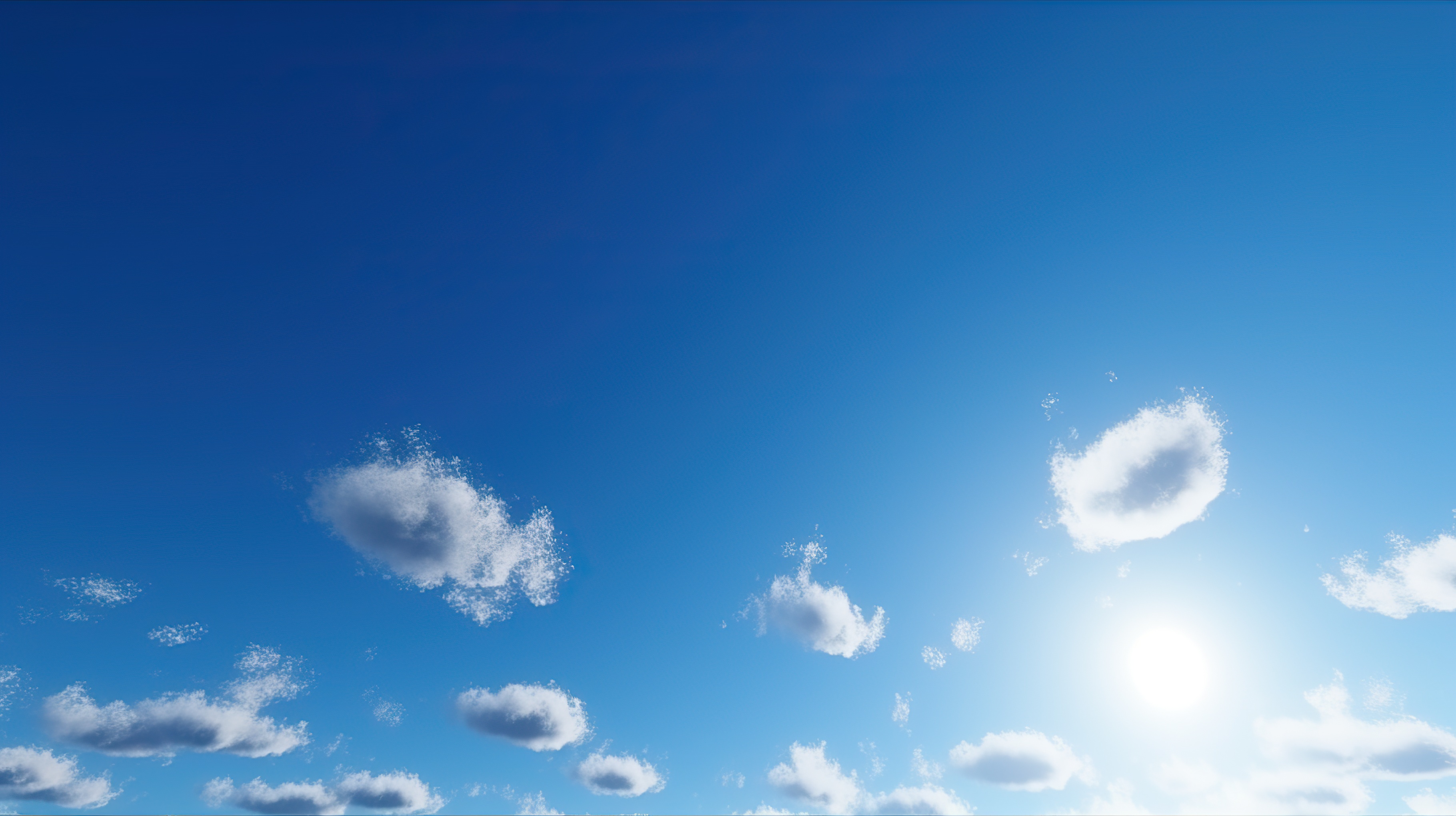 A clear blue sky with fluffy white clouds scattered throughout