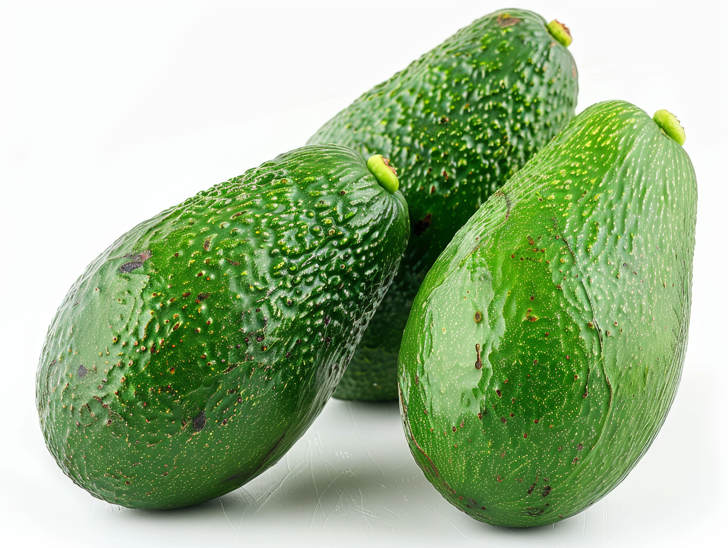 Green and fresh Avocados on white background