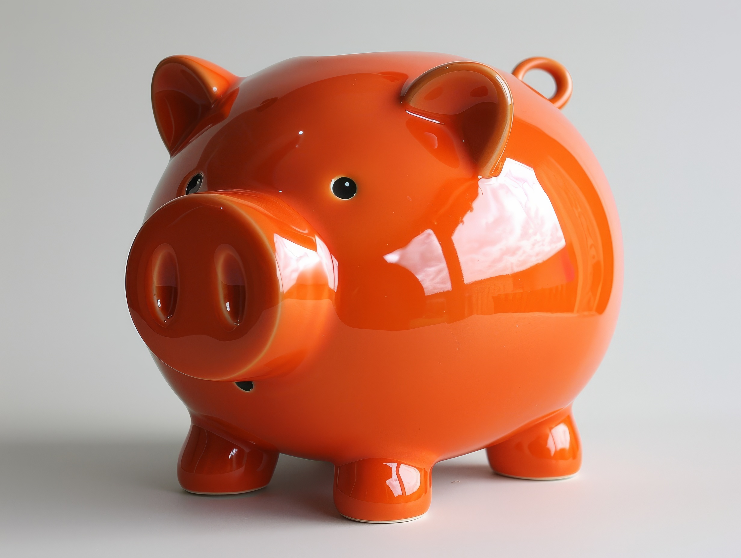 Orange ceramic piggy bank on a white background