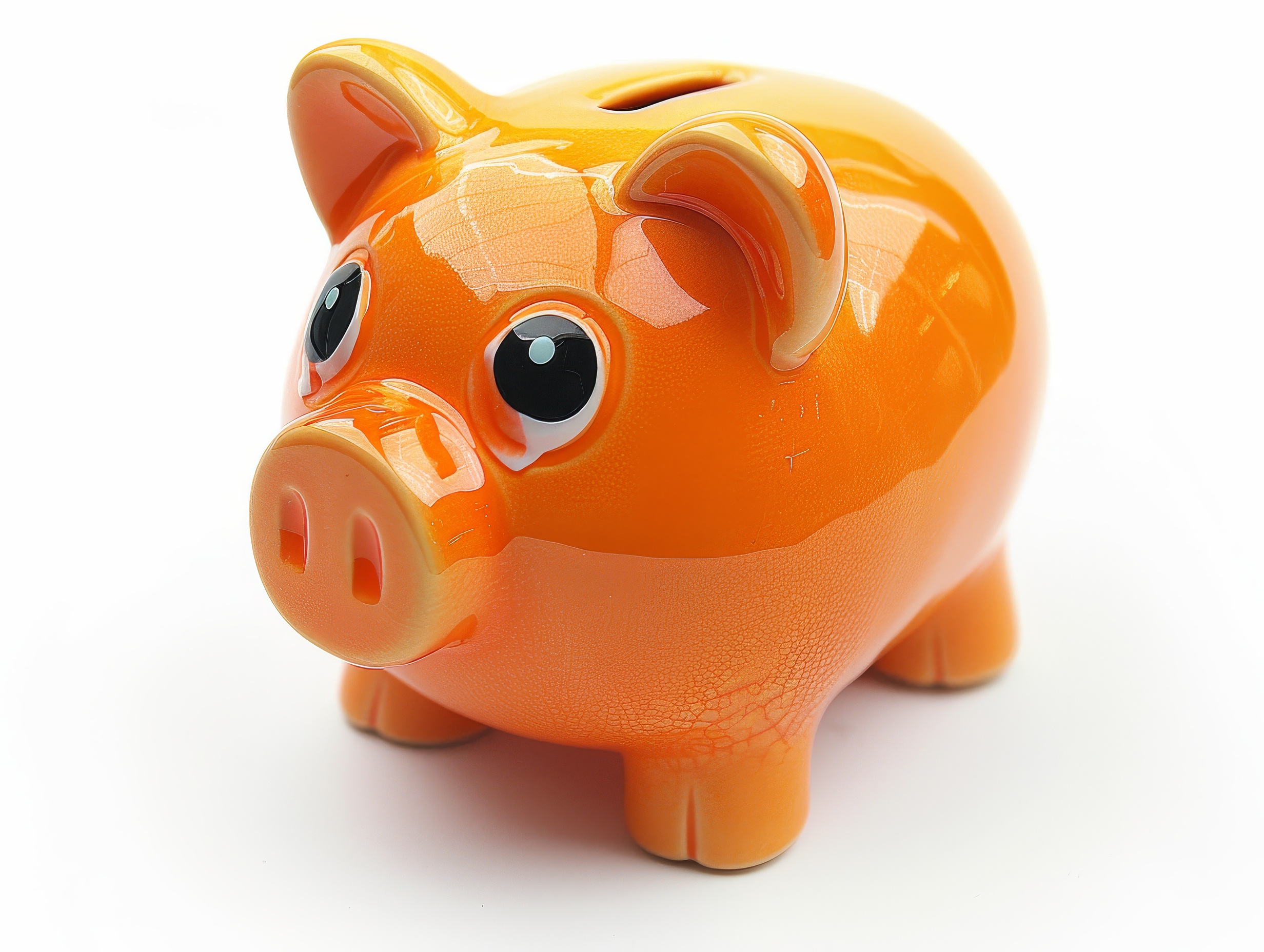 Orange ceramic piggy bank on a white background