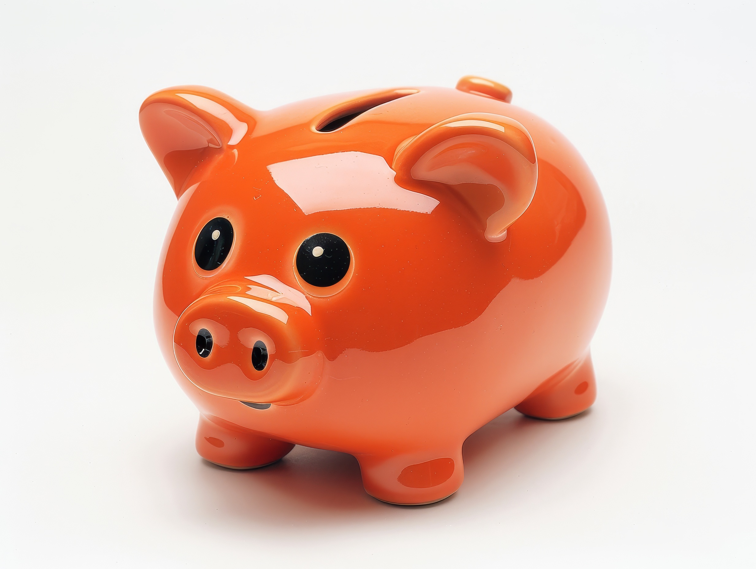 Orange ceramic piggy bank on a white background