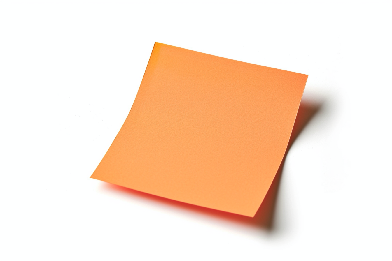 Orange colored sticky note pinned on a white background