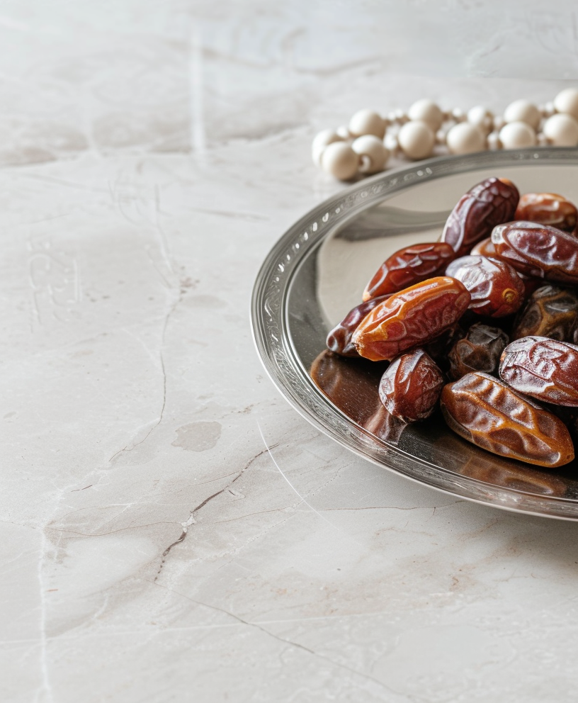 Plate with dates, decorative arabic lantern and rosary on a light background