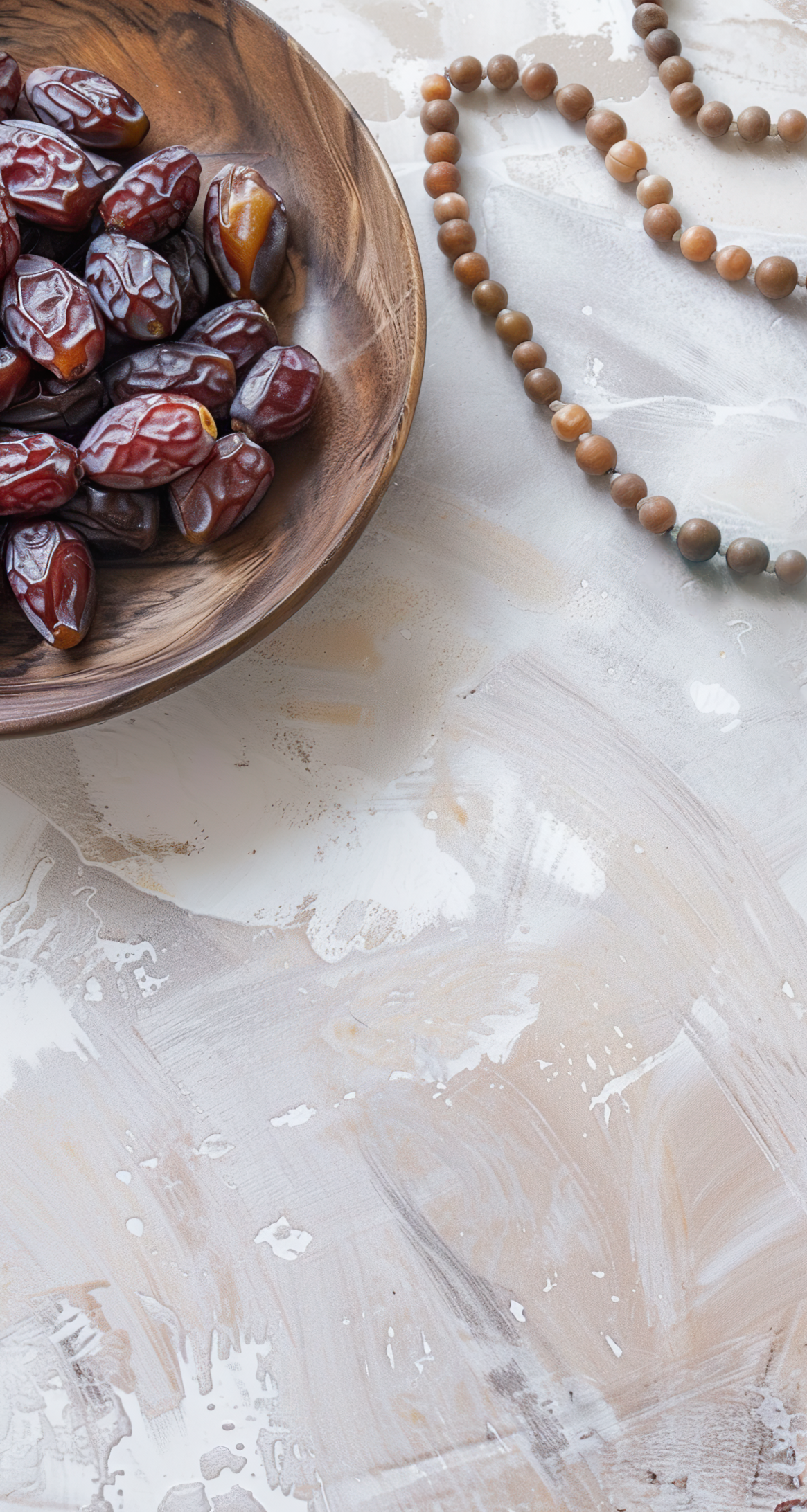 Plate with dates, decorative arabic lantern and rosary on a light background