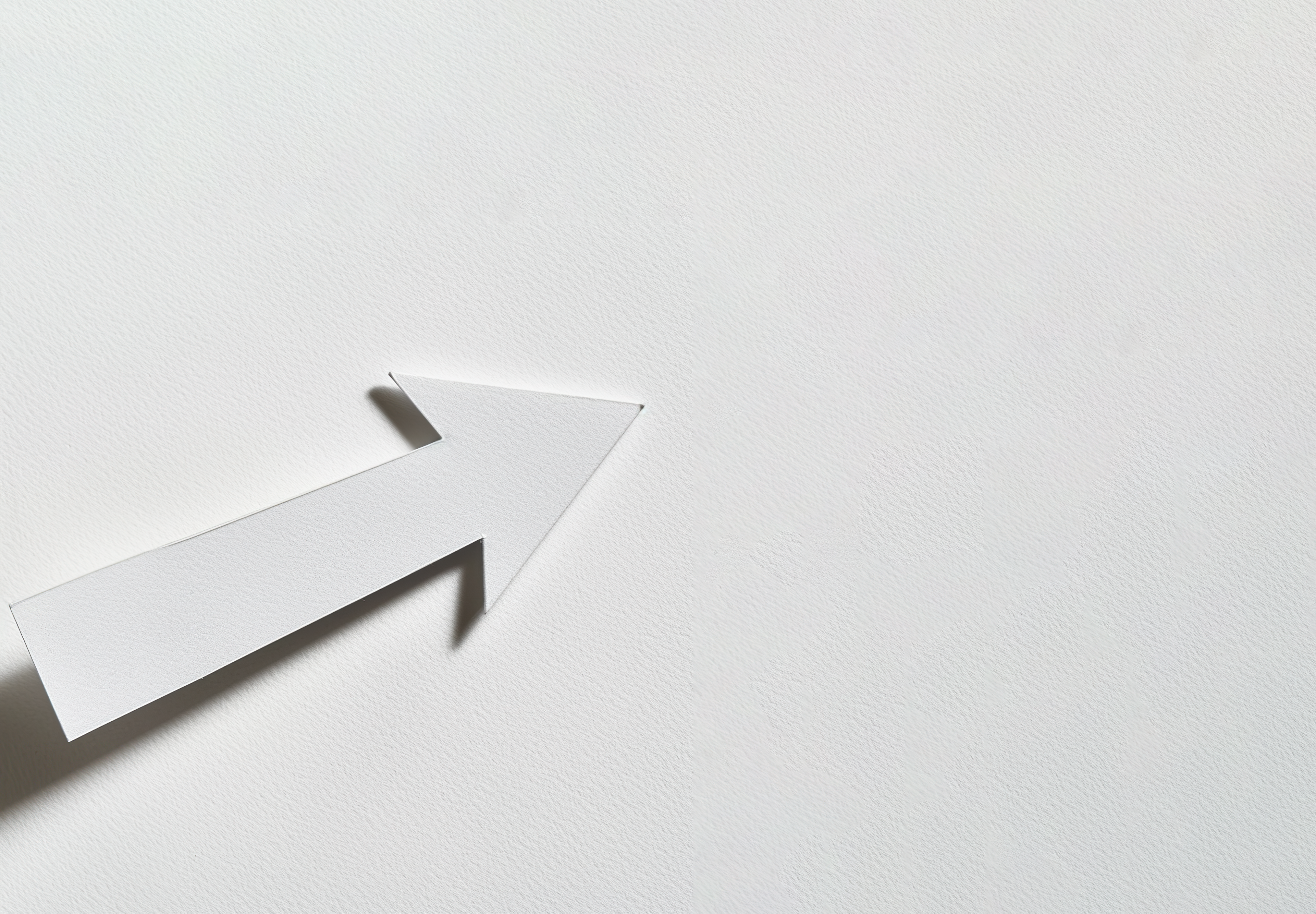 White paper arrow isolated on white paper background