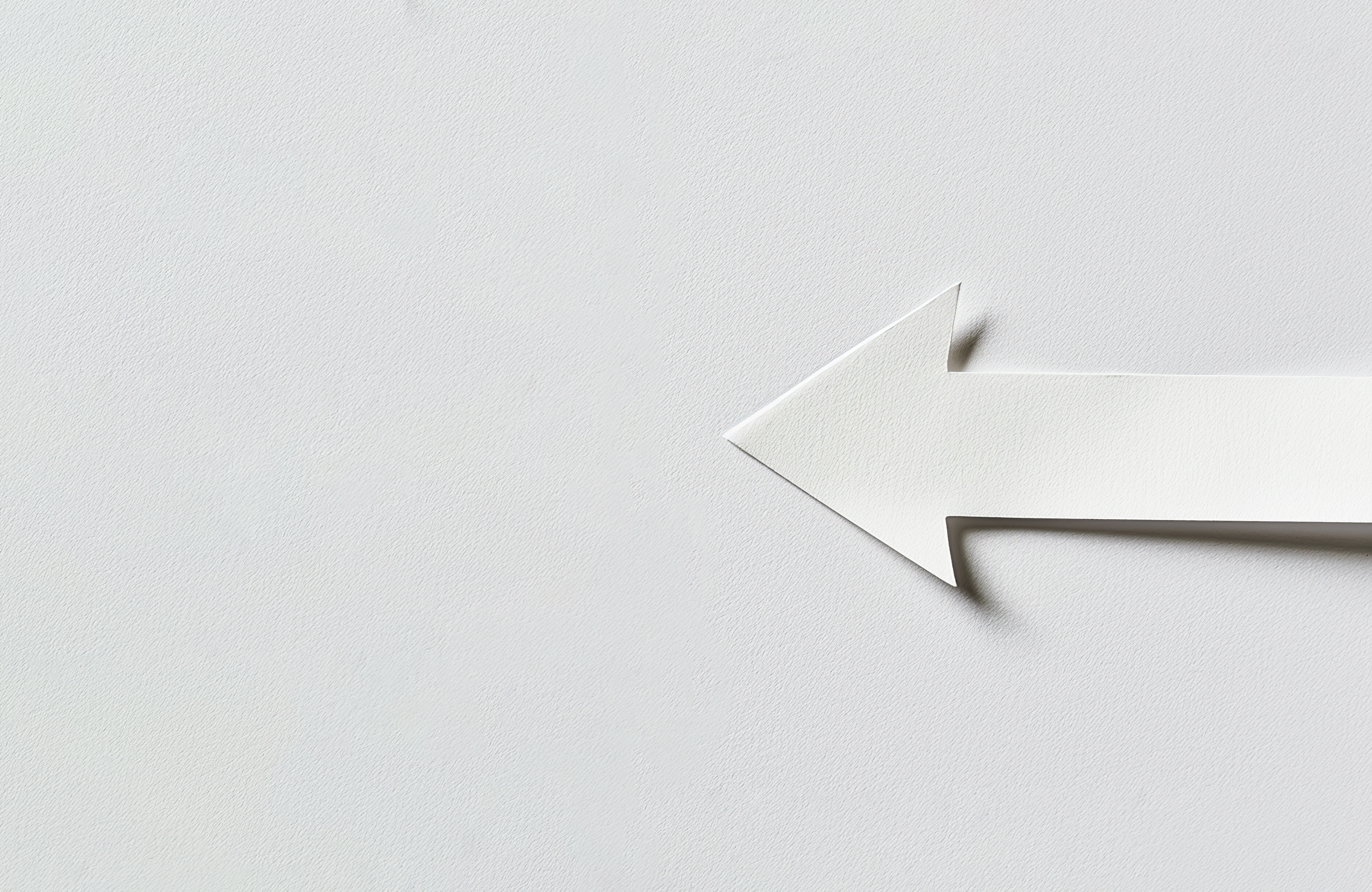 White paper arrow isolated on white paper background